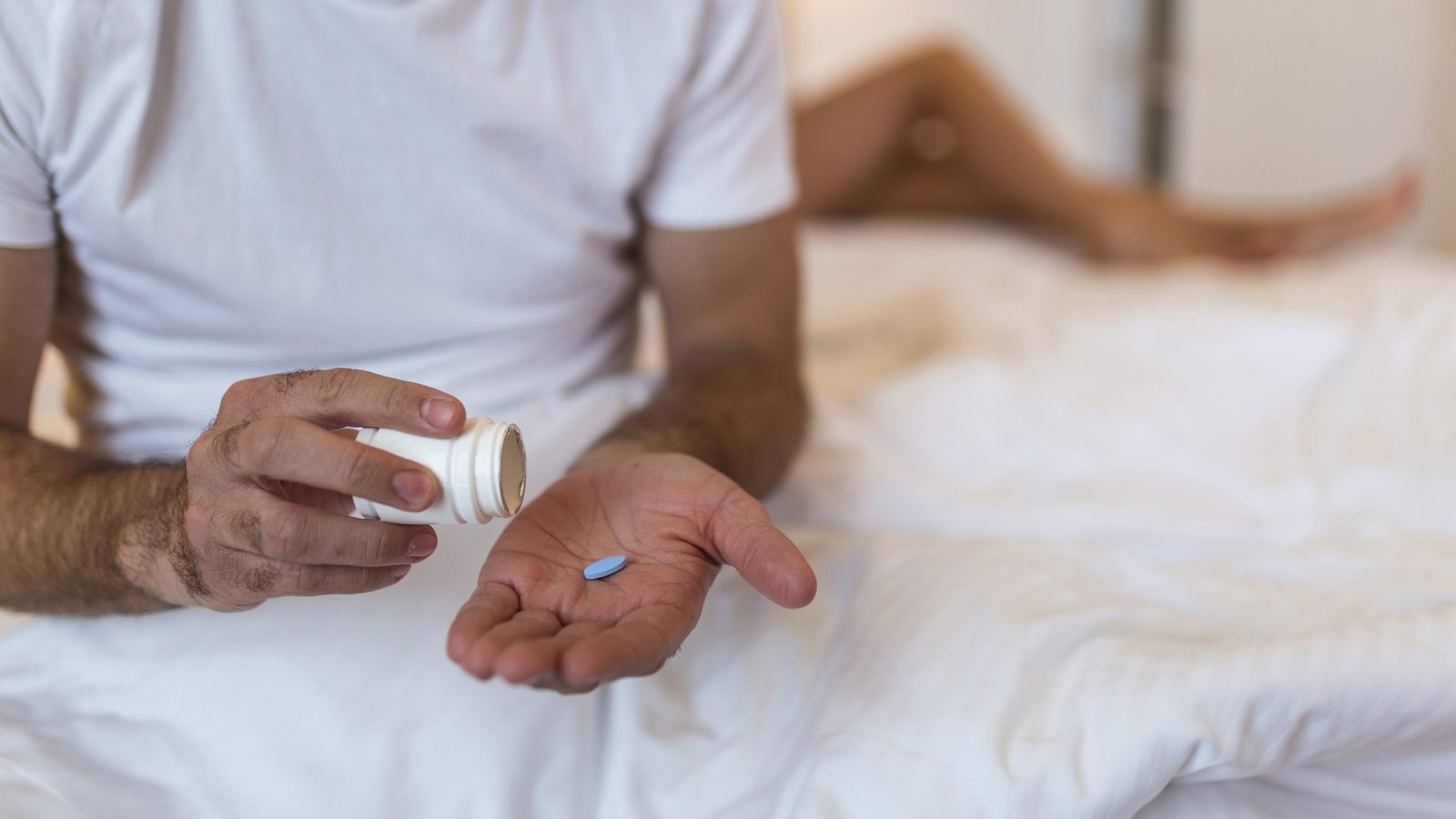 cropped_viagra_in_hand_blurred_partners_legs-1311215653.jpg